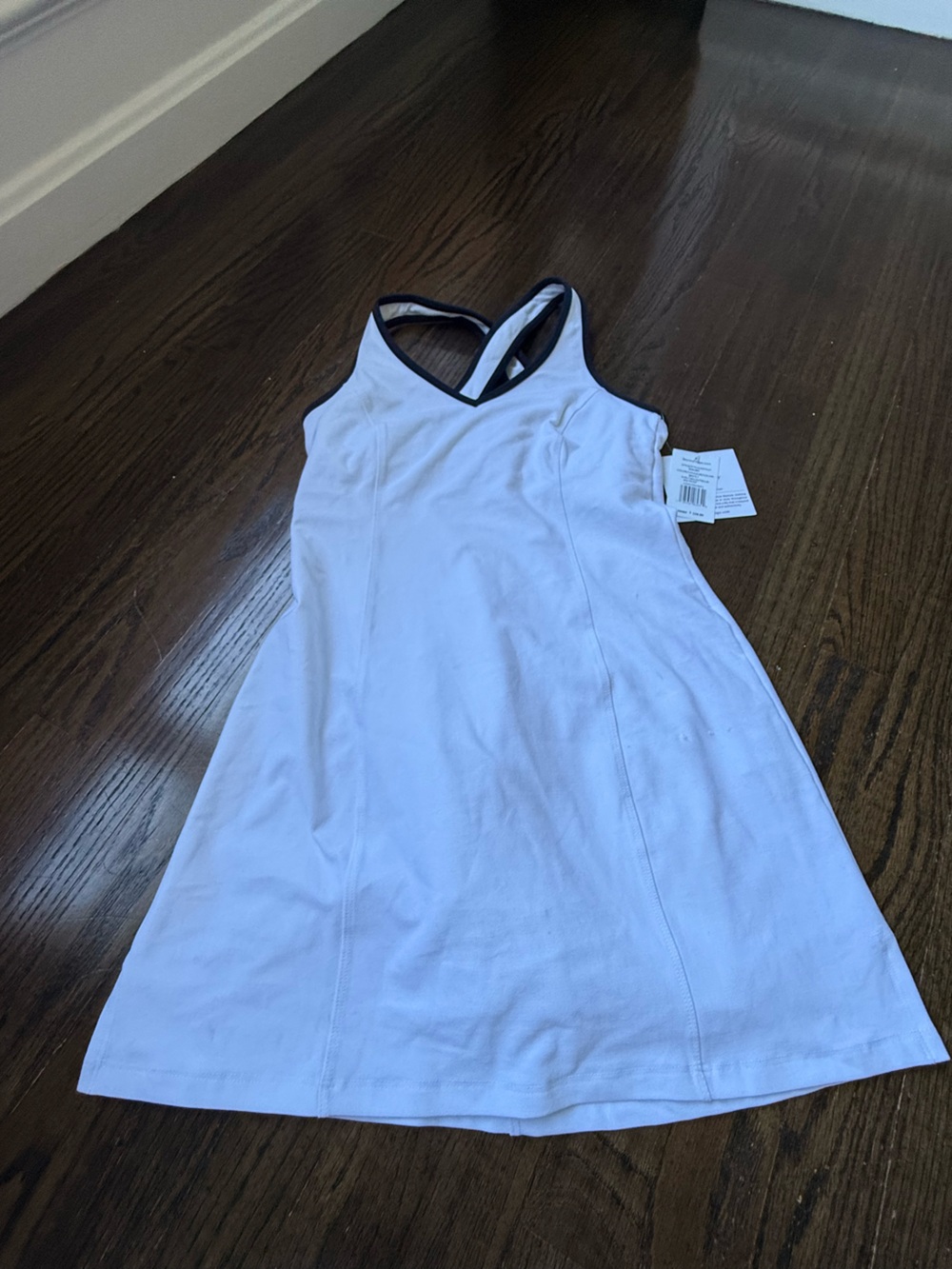 White tennis dress navy trim xs with shorts built in.  Slight pull see pic.